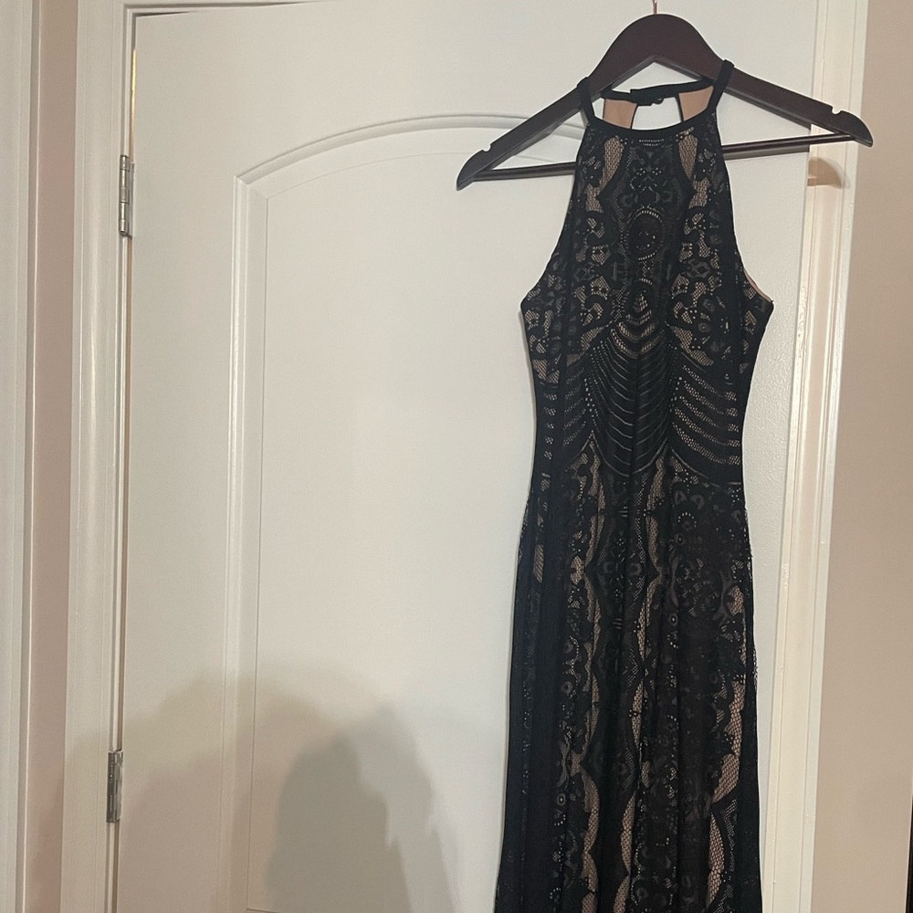 Form fitting black long dress with tan underlay. Perfect for a black tie event